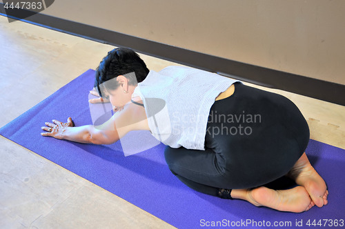 Image of Female doing yoga exercises.