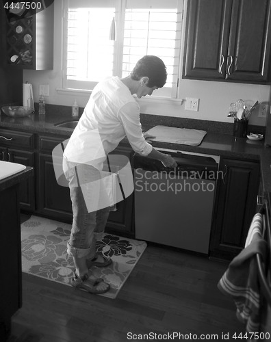 Image of Female working in the kitchen.