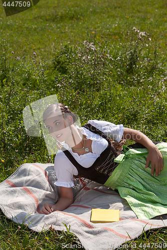 Image of Woman is lying in a meadow