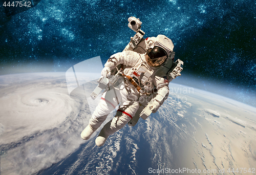 Image of Astronaut in outer space against the backdrop of the planet eart