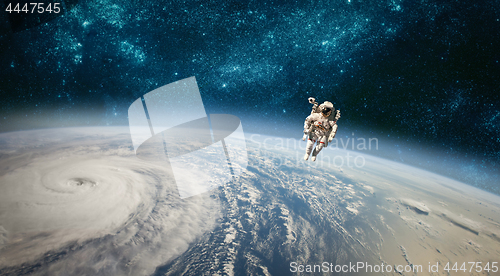 Image of Astronaut in outer space against the backdrop of the planet eart