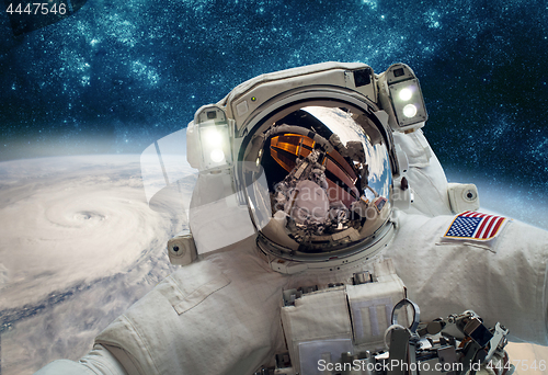 Image of Astronaut in outer space against the backdrop of the planet eart