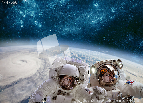 Image of Astronaut in outer space against the backdrop of the planet eart