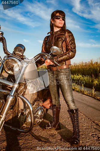 Image of Biker girl sitting on motorcycle