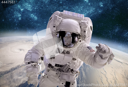 Image of Astronaut in outer space against the backdrop of the planet eart