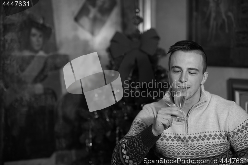 Image of Happy young man with a glass of champagne