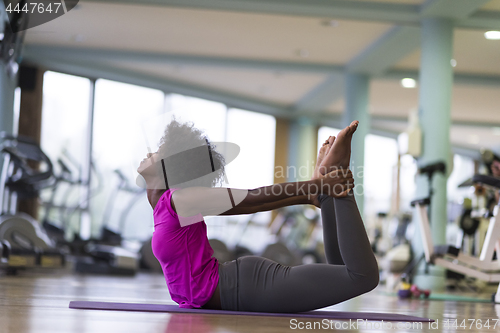 Image of african american woman exercise yoga in gym