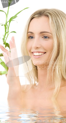 Image of happy blonde with bamboo
