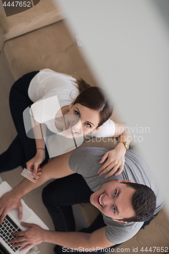 Image of happy young couple buying online