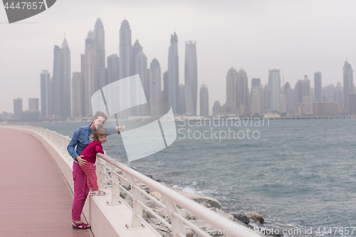 Image of mother and cute little girl on the promenade