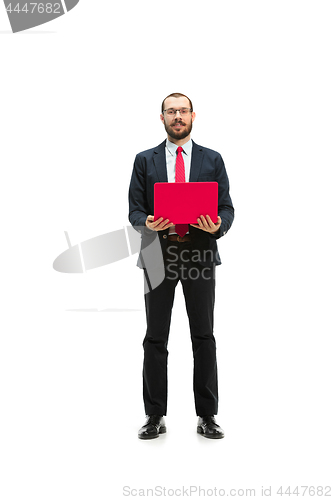 Image of Picture of handsome young bearded man standing over white studio background with laptop
