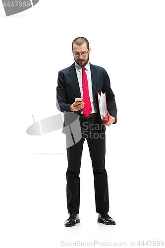 Image of Happy businessman talking on the phone with folder in hand isolated over white background in studio shooting