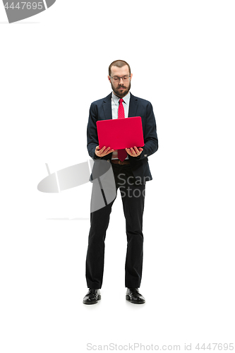 Image of Picture of handsome young bearded man standing over white studio background with laptop