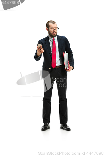 Image of Angry businessman talking on the phone isolated over white background in studio shooting