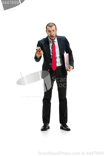 Image of Surprised businessman talking on the phone isolated over white background in studio