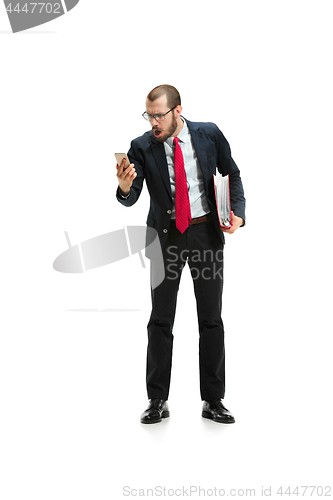 Image of Angry businessman talking on the phone isolated over white background in studio shooting