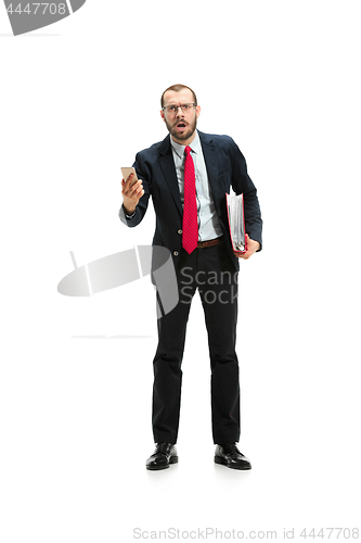 Image of Angry businessman talking on the phone isolated over white background in studio shooting