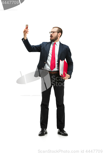 Image of Angry businessman talking on the phone isolated over white background in studio shooting