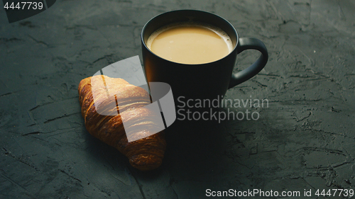 Image of Cup of coffee and croissant