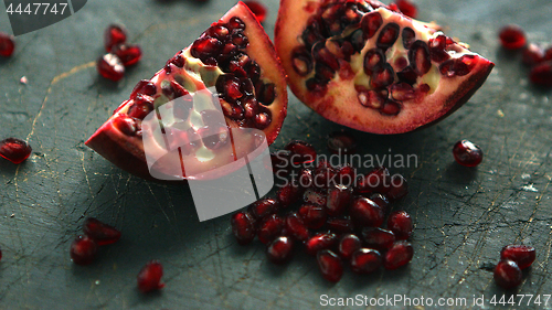 Image of Ripe pomegranate halves on board