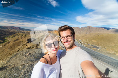 Image of Active happy couple taking selfie on travel in high Atlas mountains, Ouarzazate, Morocco.