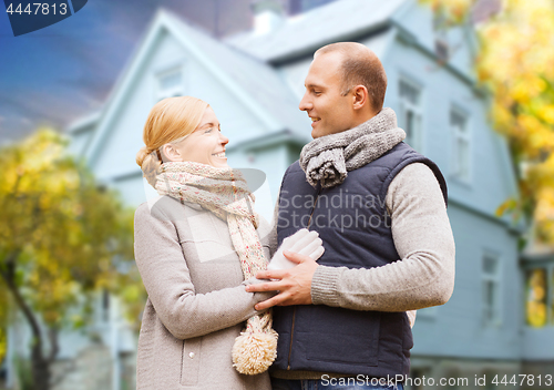 Image of happy couple over living house in autumn