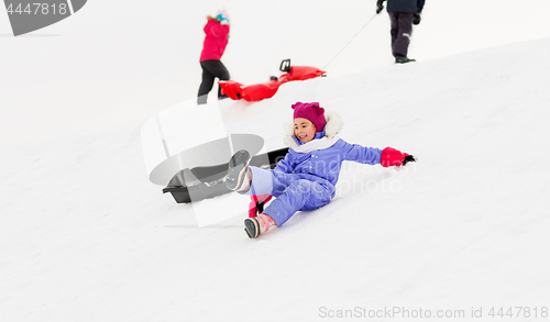 Image of little kids with sleds on snow hill in winter