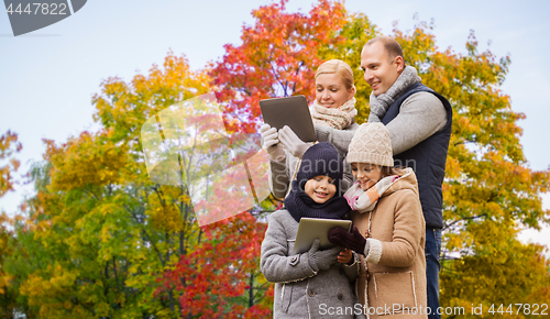 Image of family with tablet pc computers over autumn park