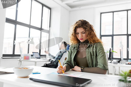 Image of creative woman working on user interface at office