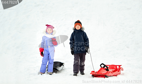 Image of happy little kids with sleds in winter