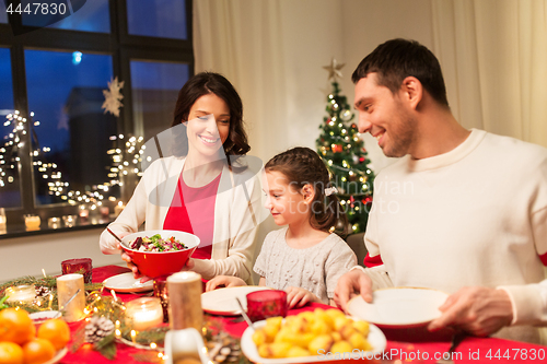 Image of happy family having christmas dinner at home