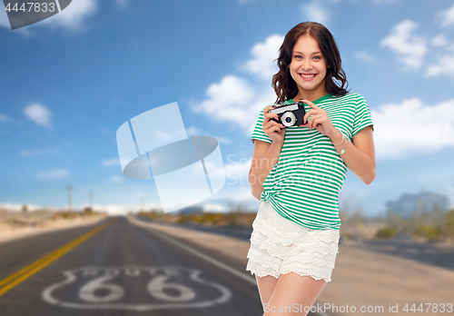 Image of teenage girl with vintage film camera on route 66