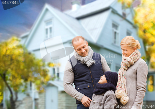 Image of happy family over living house in autumn