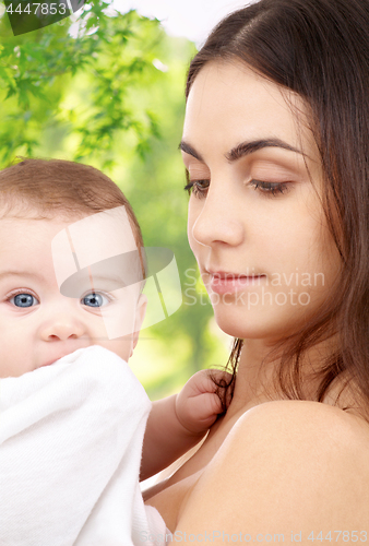 Image of mother with baby over green natural background