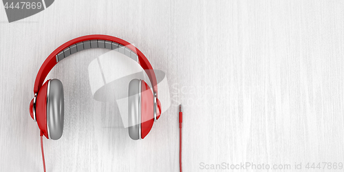 Image of Big red headphones on wood background