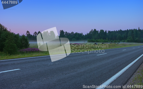 Image of Empty Straight Asphalt Road In A Misty Morning Twilight