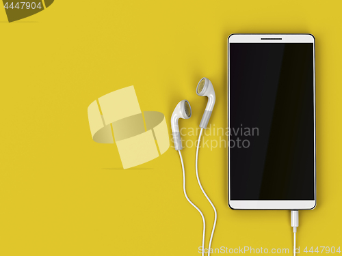 Image of Smartphone and wired earphones on yellow background