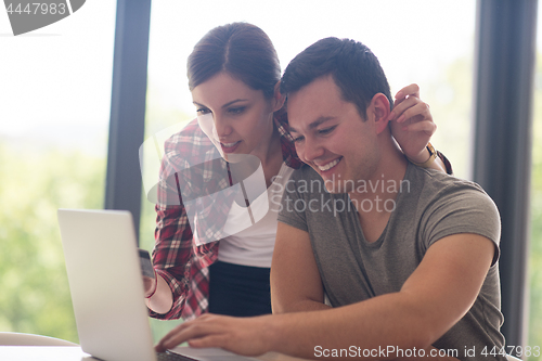 Image of happy young couple buying online