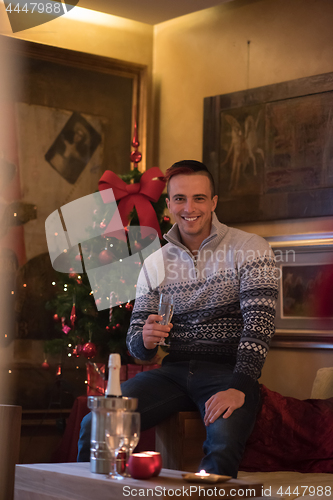 Image of Happy young man with a glass of champagne