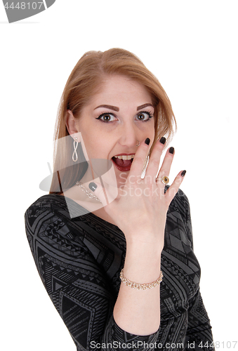 Image of Surprised young woman, hand on face