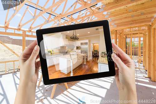 Image of Female Hands Holding Computer Tablet with Finished Kitchen on Sc