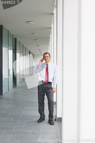 Image of Businessman talking on cell phone