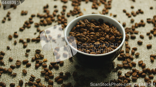 Image of Cup of coffee beans on canvas