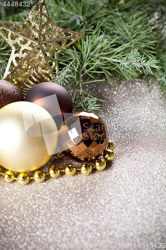 Image of Christmas decorations and evergreen fir tree branch.