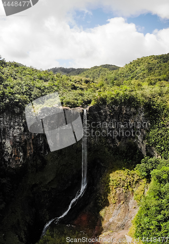 Image of Aerial top view perspective of amazing 500 feet tall waterfall in the tropical island jungle of Mauritius.