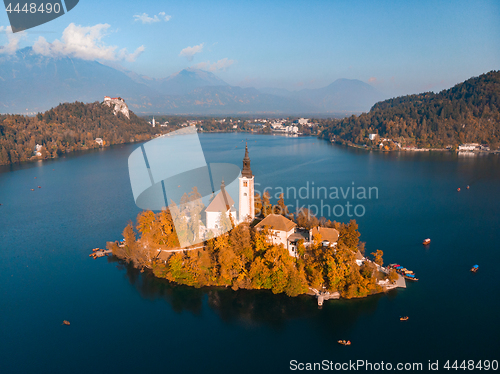 Image of Aerial view of Bled island on lake Bled, and Bled castle and mountains in background, Slovenia.