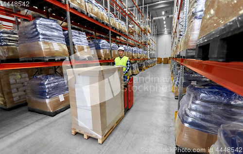 Image of loader operating forklift at warehouse