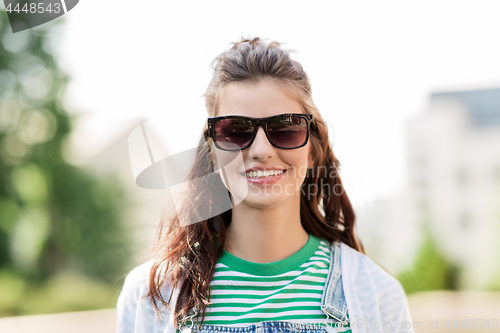 Image of portrait of young woman in sunglasses outdoors