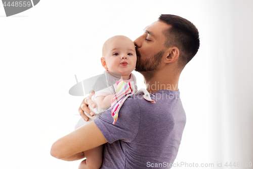 Image of father kissing little baby daughter