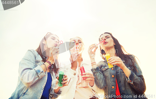 Image of young women or girls blowing bubbles outdoors